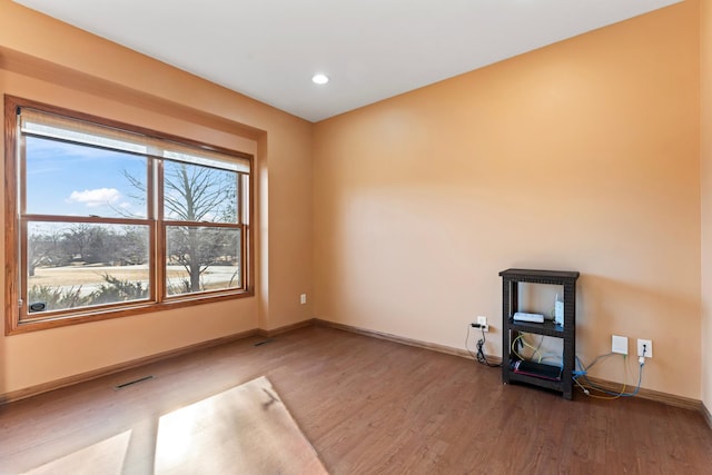 unfurnished room featuring recessed lighting, visible vents, baseboards, and wood finished floors