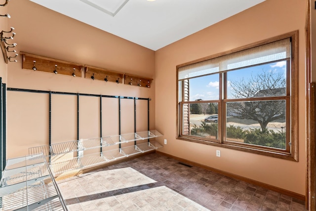 spare room featuring visible vents and baseboards