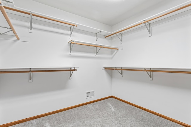 walk in closet featuring visible vents and carpet flooring