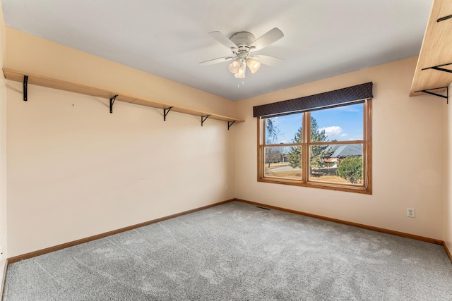 spare room featuring carpet flooring, a ceiling fan, and baseboards