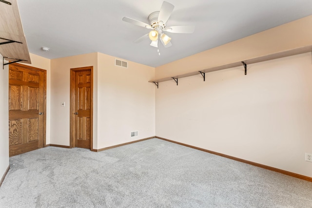 unfurnished bedroom with a ceiling fan, carpet, visible vents, and baseboards