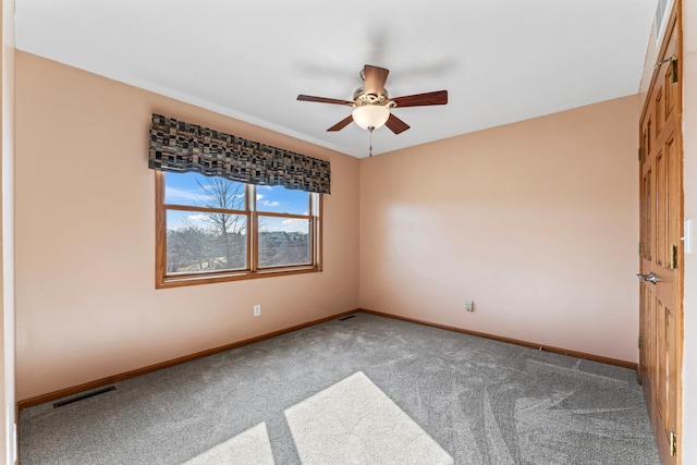 empty room featuring visible vents, baseboards, carpet, and ceiling fan