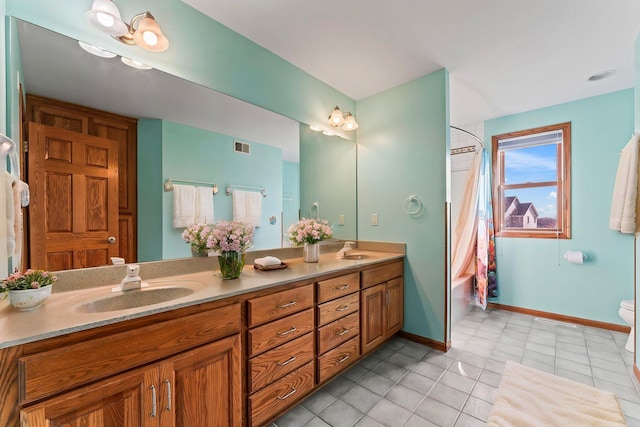3135 Sherburn Pl SW, Rochester, MN 55902 - bathroom featuring double vanity, tile patterned flooring, baseboards, toilet, and shower / tub combo with curtain