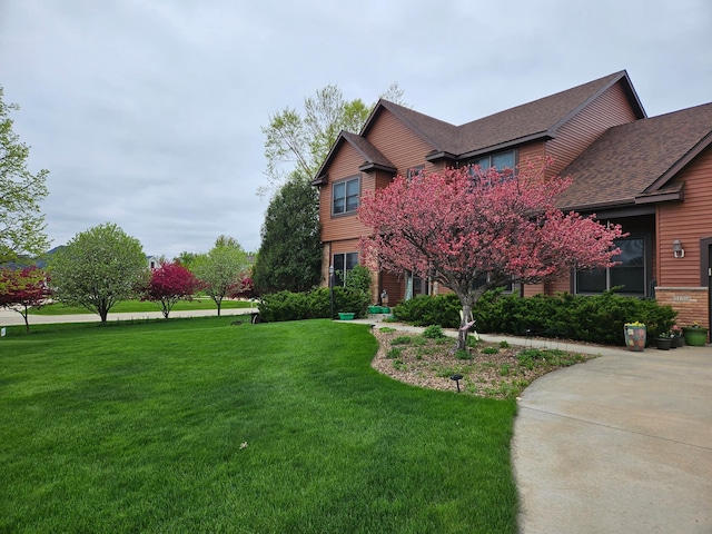 3135 Sherburn Pl SW, Rochester, MN 55902 - view of front facade with a front yard and roof with shingles