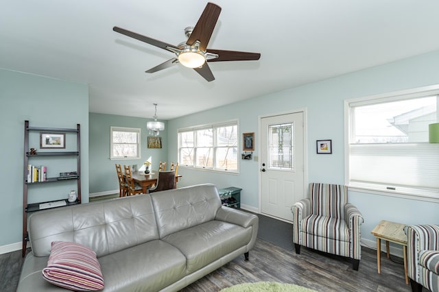 living room featuring wood finished floors, baseboards, and ceiling fan