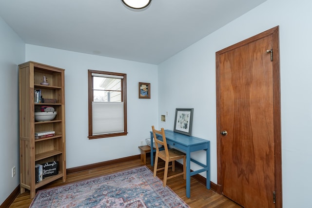 office area with baseboards and wood finished floors