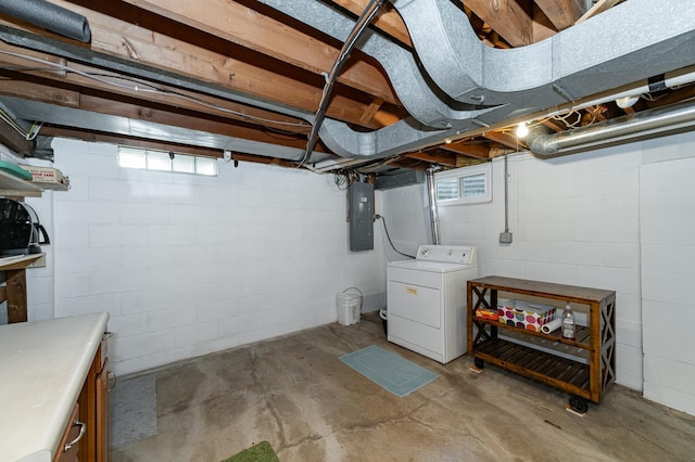 basement featuring electric panel and washer / clothes dryer