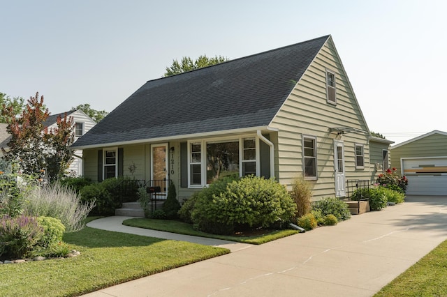 view of front of property with an outbuilding and roof with shingles