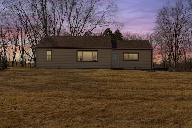 view of front facade with a front lawn and a shingled roof