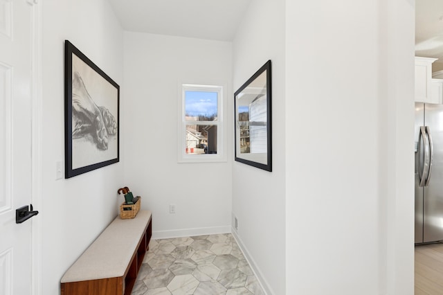 hallway featuring baseboards