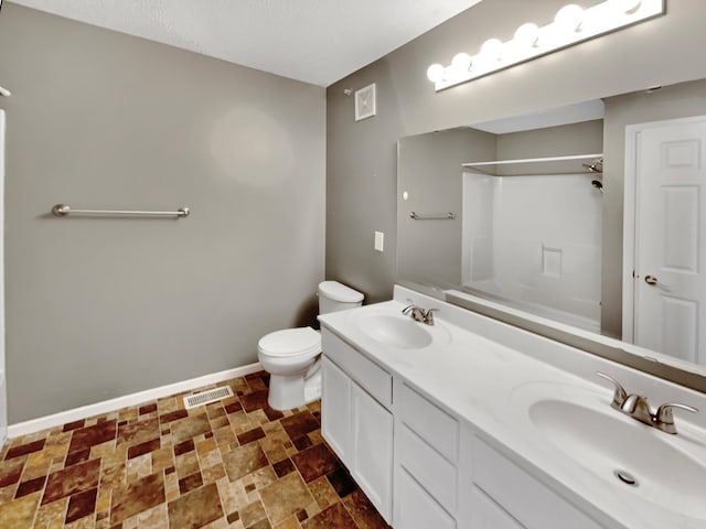 bathroom featuring a sink, visible vents, baseboards, and toilet