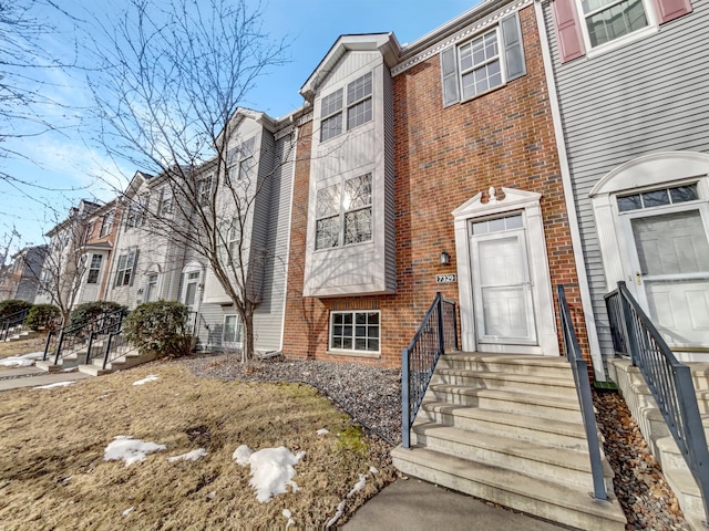 townhome / multi-family property with brick siding