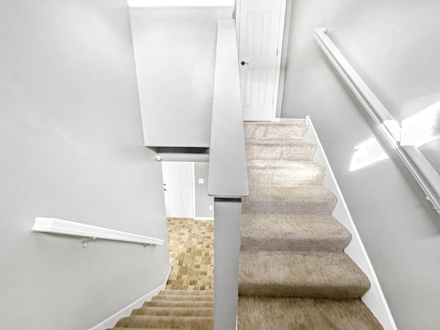 staircase featuring baseboards