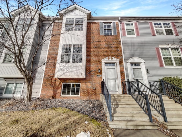 view of property featuring brick siding