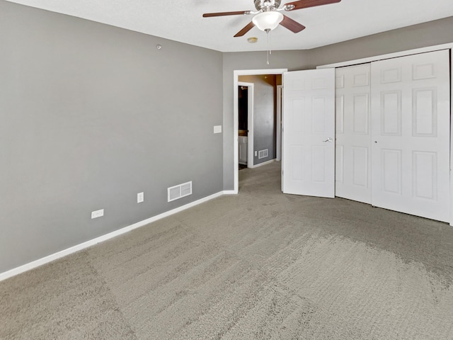 unfurnished bedroom with carpet flooring, baseboards, visible vents, and ceiling fan