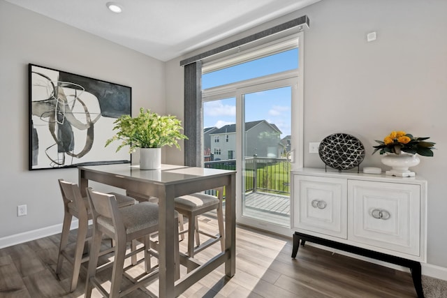 dining room with recessed lighting, baseboards, and light wood-style flooring