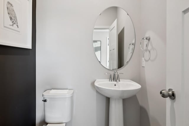 half bath featuring a sink and toilet