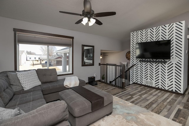 living area featuring a textured ceiling, wood finished floors, and a ceiling fan