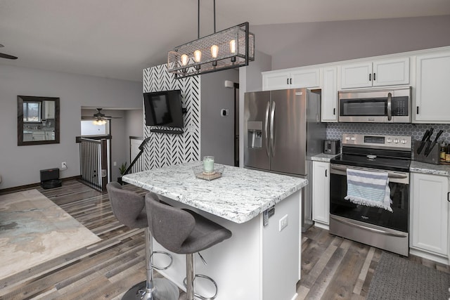 kitchen featuring dark wood-type flooring, white cabinets, pendant lighting, and stainless steel appliances