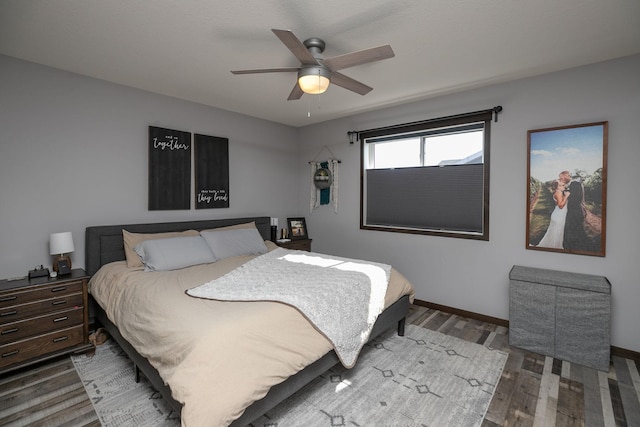 bedroom with ceiling fan, baseboards, and wood finished floors