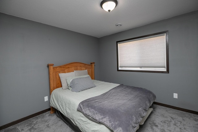 bedroom featuring carpet flooring and baseboards