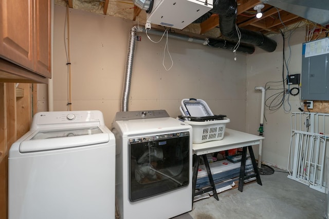 clothes washing area featuring electric panel, cabinet space, and independent washer and dryer