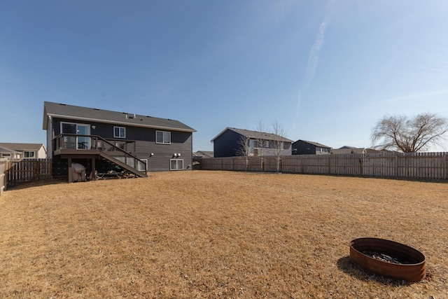 view of yard featuring stairs and a fenced backyard