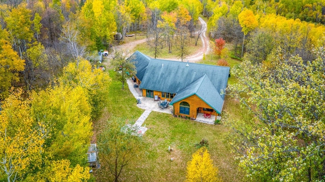 birds eye view of property with a forest view