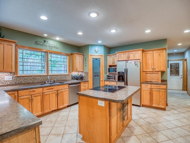 kitchen with a kitchen island, recessed lighting, a sink, decorative backsplash, and stainless steel appliances