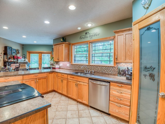 kitchen with decorative backsplash, recessed lighting, stainless steel dishwasher, a textured ceiling, and a sink