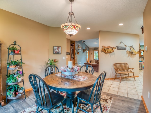 dining space with recessed lighting, wood finished floors, baseboards, and a textured ceiling