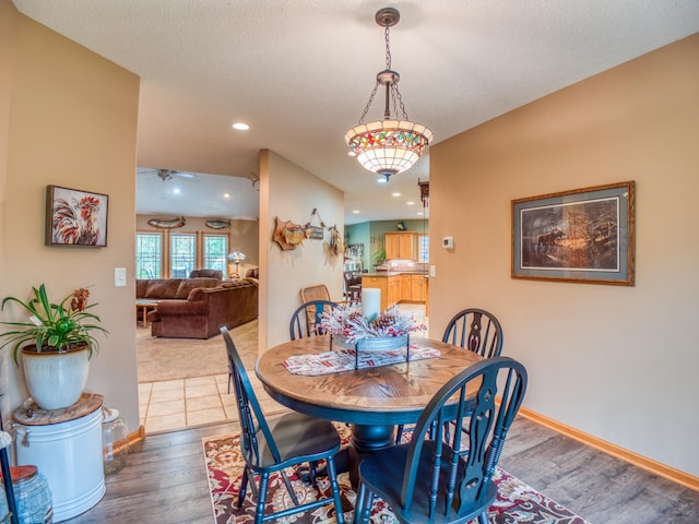 dining room with recessed lighting, wood finished floors, baseboards, and a textured ceiling