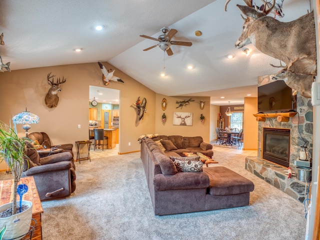 carpeted living room featuring baseboards, a stone fireplace, a ceiling fan, and lofted ceiling