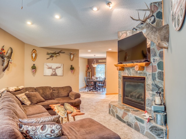 living area featuring recessed lighting, carpet, a fireplace, and a textured ceiling