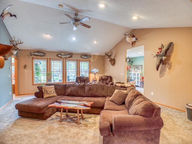 carpeted living room with ceiling fan, vaulted ceiling, baseboards, and a textured ceiling