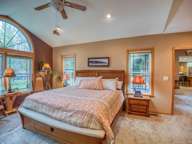 carpeted bedroom with visible vents, lofted ceiling, a ceiling fan, a textured ceiling, and baseboards