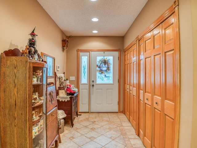 entryway with recessed lighting and a textured ceiling