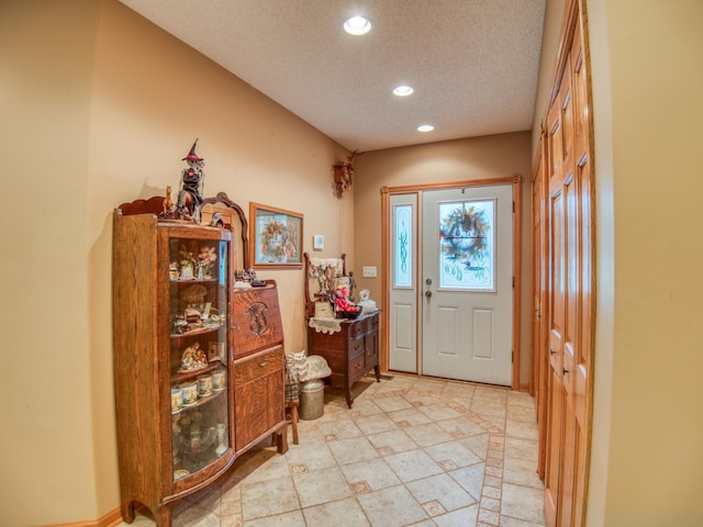 foyer entrance with recessed lighting and a textured ceiling