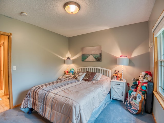 bedroom featuring carpet floors and a textured ceiling