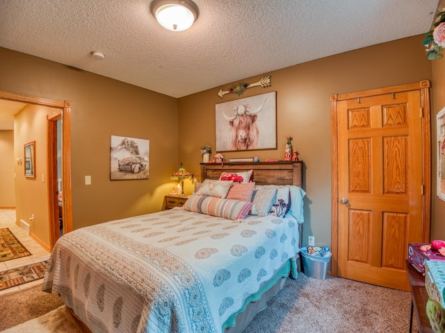 carpeted bedroom with a textured ceiling