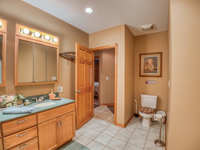 ensuite bathroom with toilet, a textured ceiling, ensuite bath, tile patterned flooring, and vanity