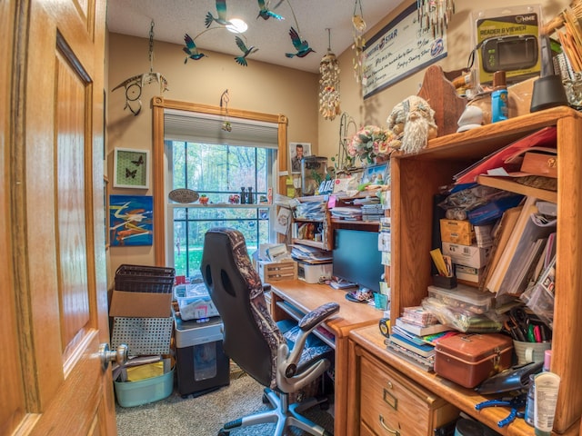 carpeted home office with a textured ceiling