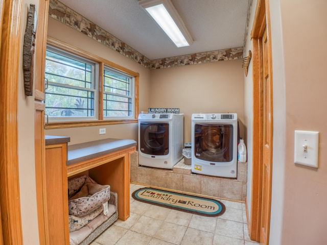 laundry area featuring separate washer and dryer, laundry area, and tile patterned flooring