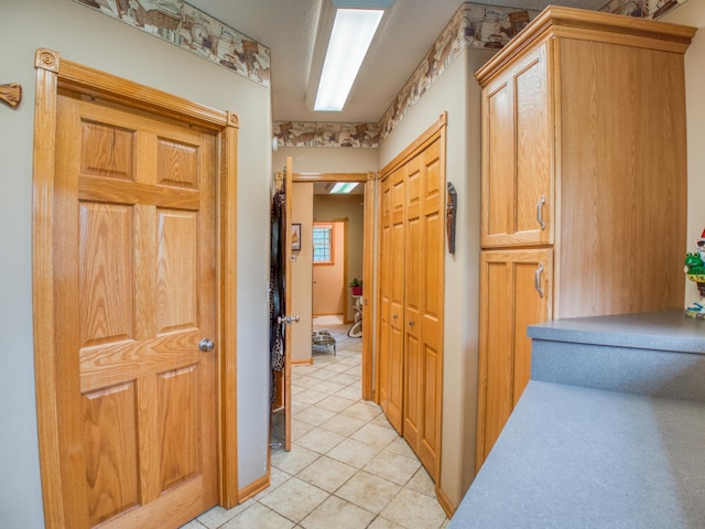 hall with light tile patterned floors