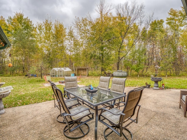 view of patio featuring an exterior structure, outdoor dining area, and an outdoor structure