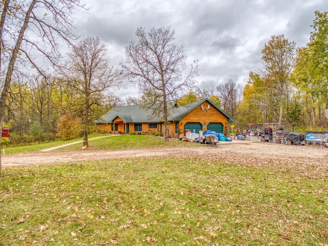 view of front of house with a garage and a front lawn