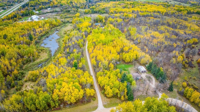 aerial view with a forest view and a water view