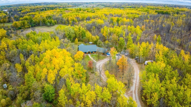 bird's eye view with a wooded view