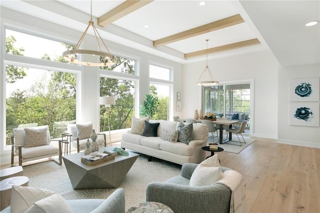 living room featuring beam ceiling, recessed lighting, wood-type flooring, an inviting chandelier, and baseboards