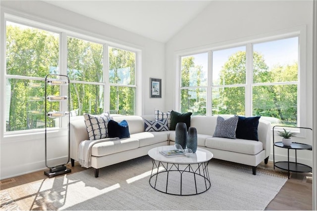 sunroom / solarium with visible vents and lofted ceiling